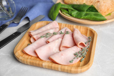 Tasty fresh ham on light grey marble table