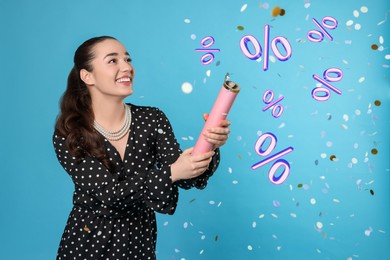Image of Discount offer. Happy young woman blowing up party popper on light blue background. Confetti and percent signs in air