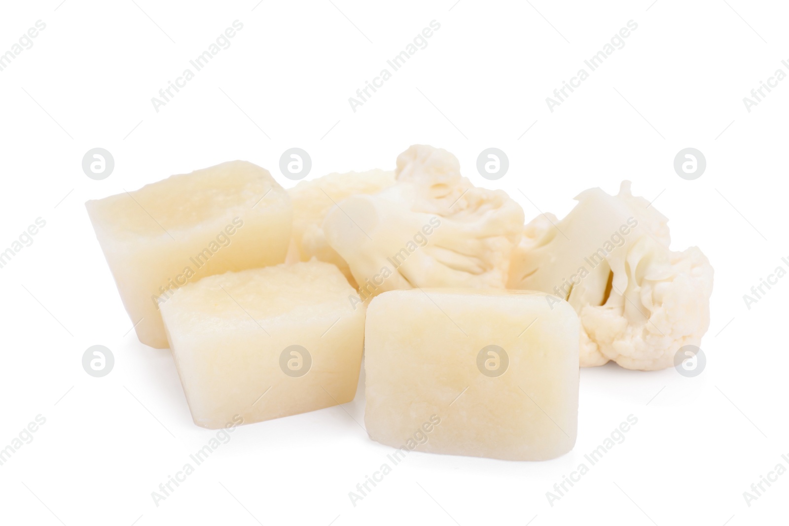 Photo of Frozen cauliflower puree cubes and fresh cauliflower isolated on white