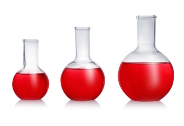 Photo of Florence flasks with red liquid on white background. Laboratory glassware