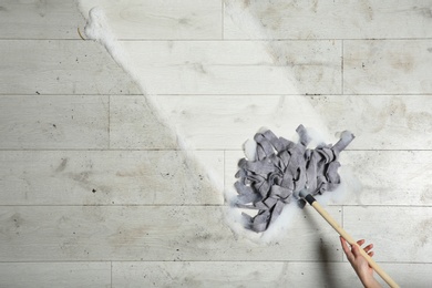 Photo of Professional cleaner washing dirty floor with mop, top view. Space for text