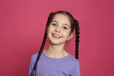 Photo of Portrait of little girl laughing on color background