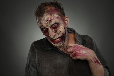 Scary zombie on dark background. Halloween monster