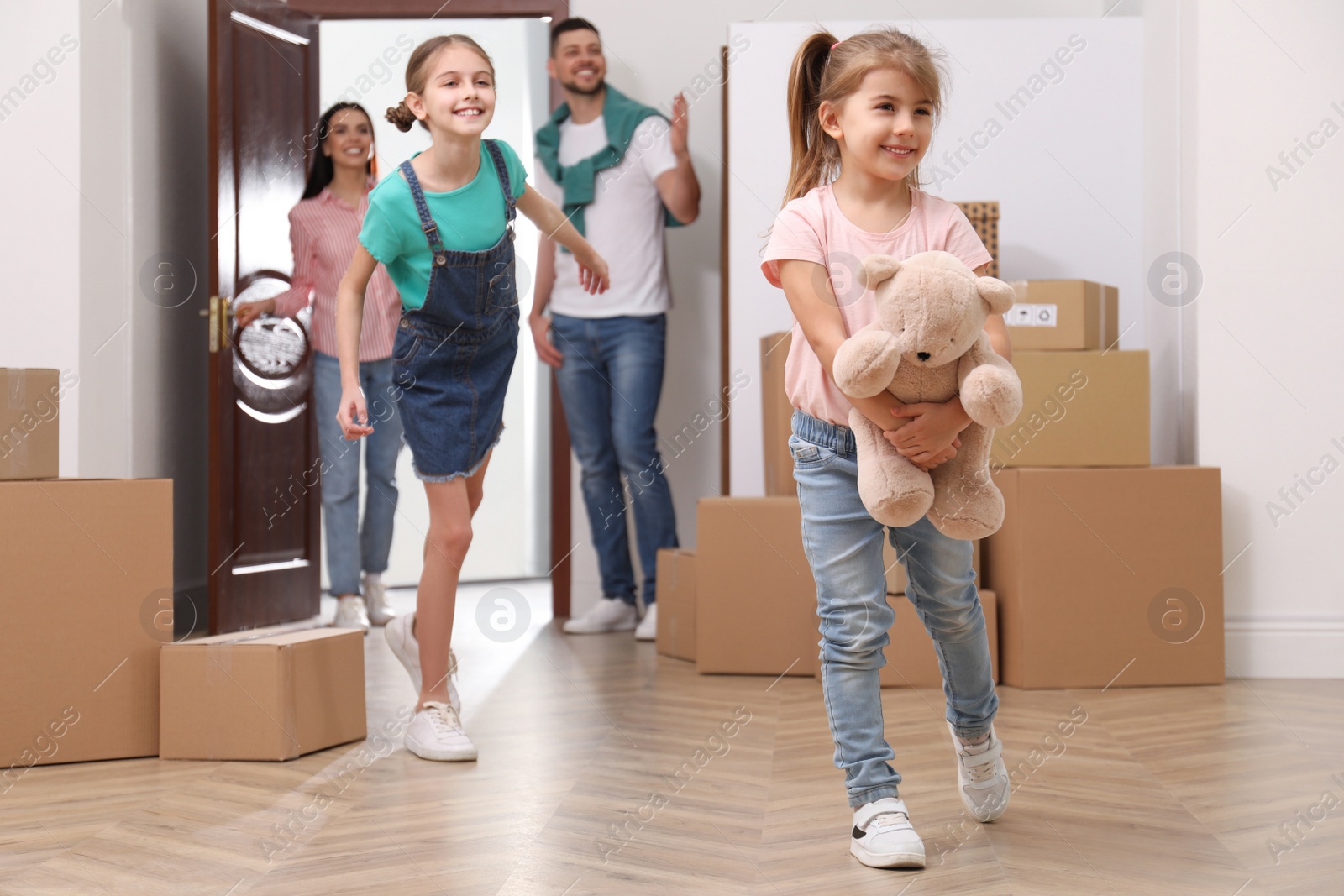 Photo of Happy family with children moving into new house