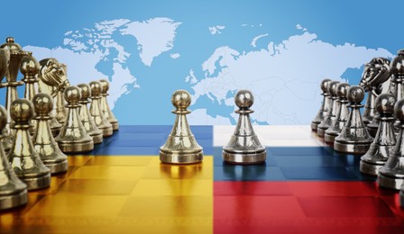 Image of Concept of war between Ukraine and Russia. Chess pieces on board in color of national flags against world map