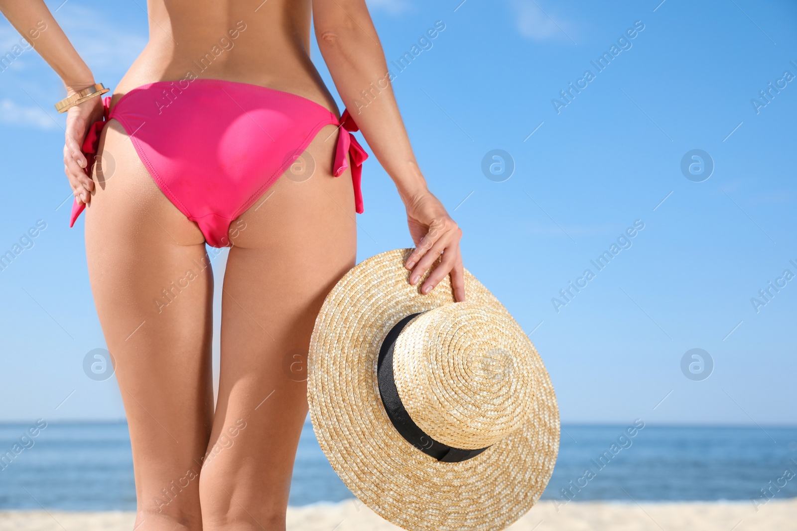 Photo of Young woman with beautiful body on beach, closeup