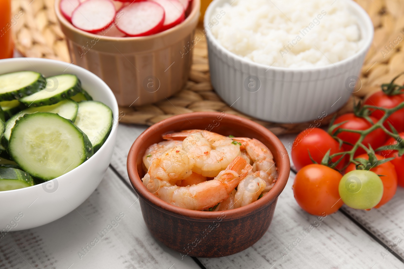 Photo of Ingredients for poke bowl on white wooden table, closeup