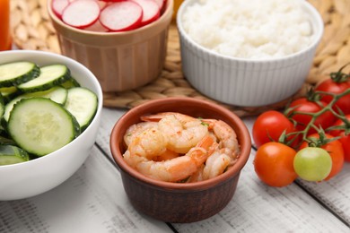Ingredients for poke bowl on white wooden table, closeup