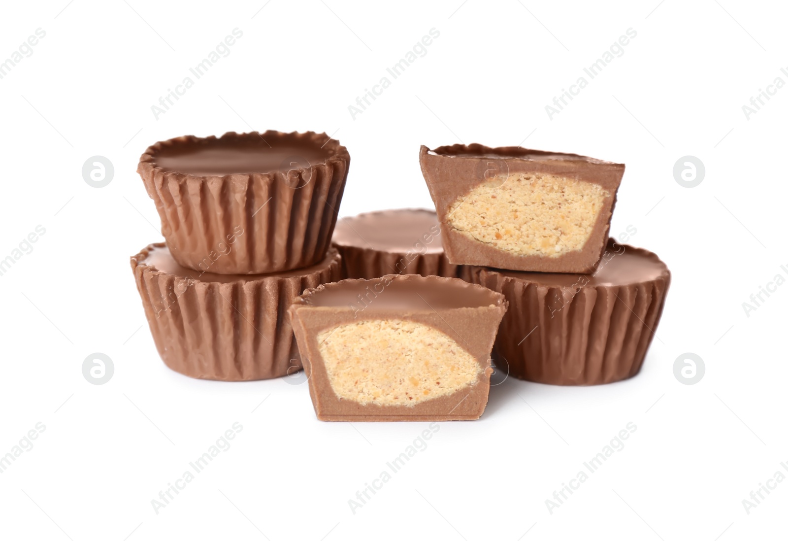 Photo of Cut and whole peanut butter cups isolated on white