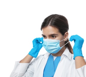 Photo of Doctor in medical gloves putting on protective mask against white background