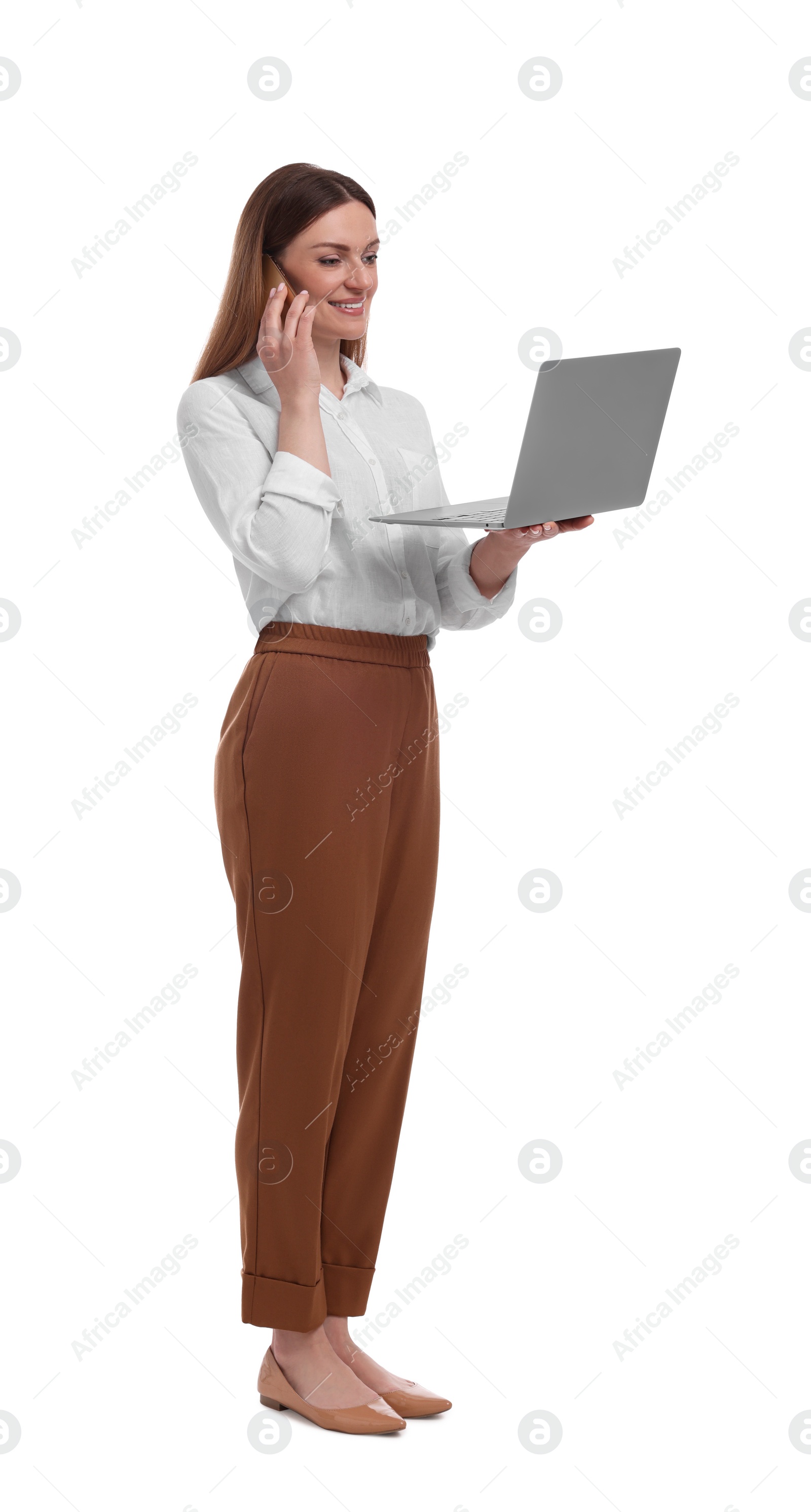 Photo of Beautiful businesswoman with laptop talking on phone against white background