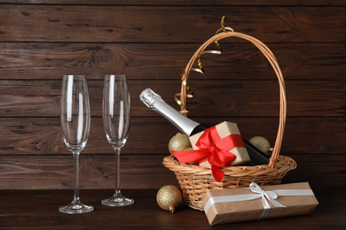 Photo of Christmas composition with bottle of champagne and glasses on wooden background