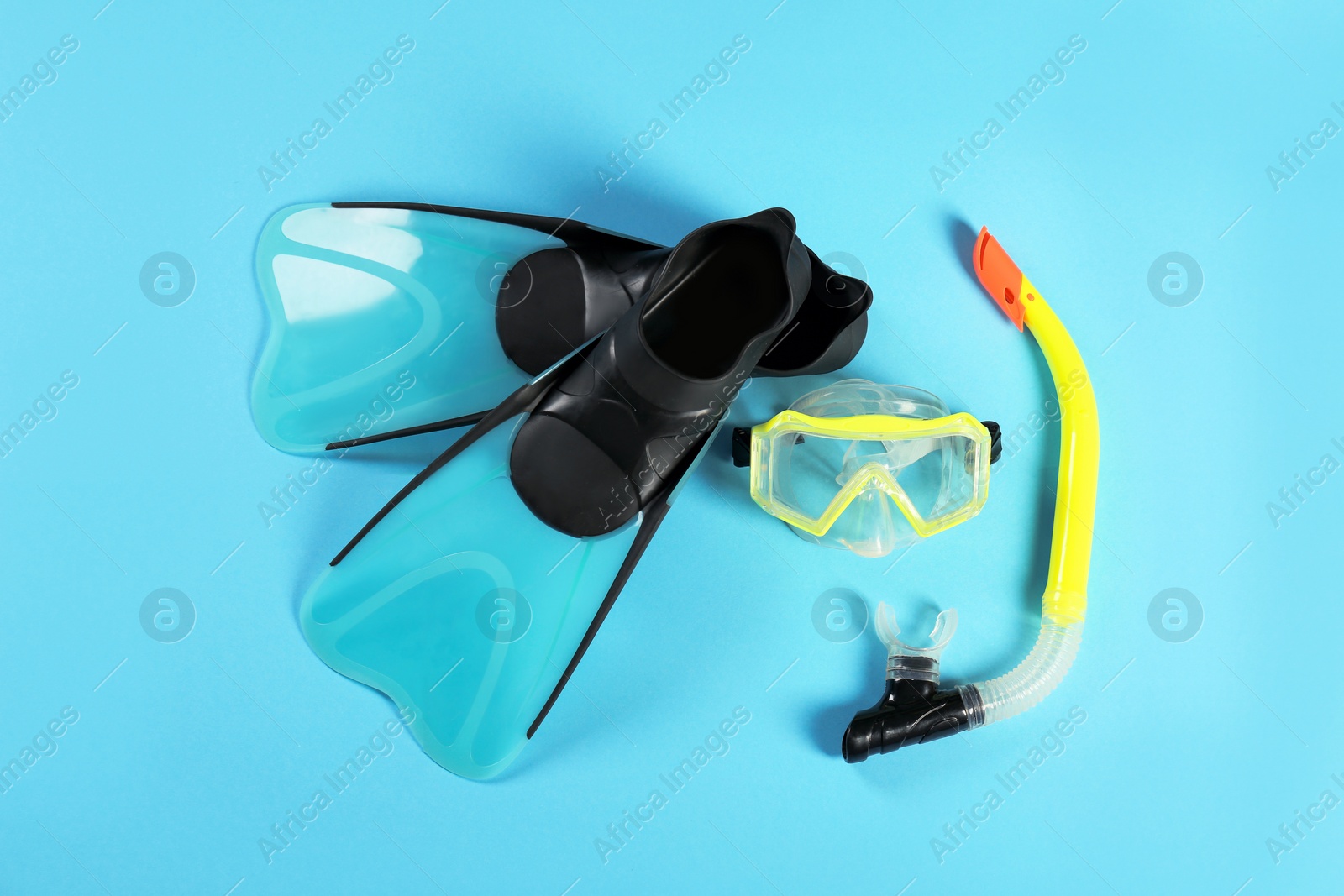Photo of Swimming flippers and mask on color background, top view