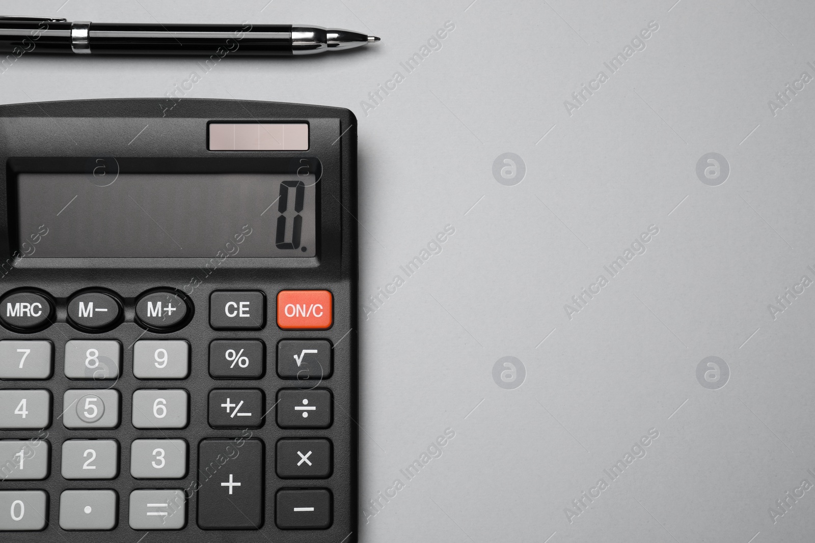 Photo of Calculator and pen on light grey background, flat lay with space for text