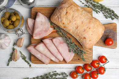 Photo of Tasty ham served on white wooden table, flat lay