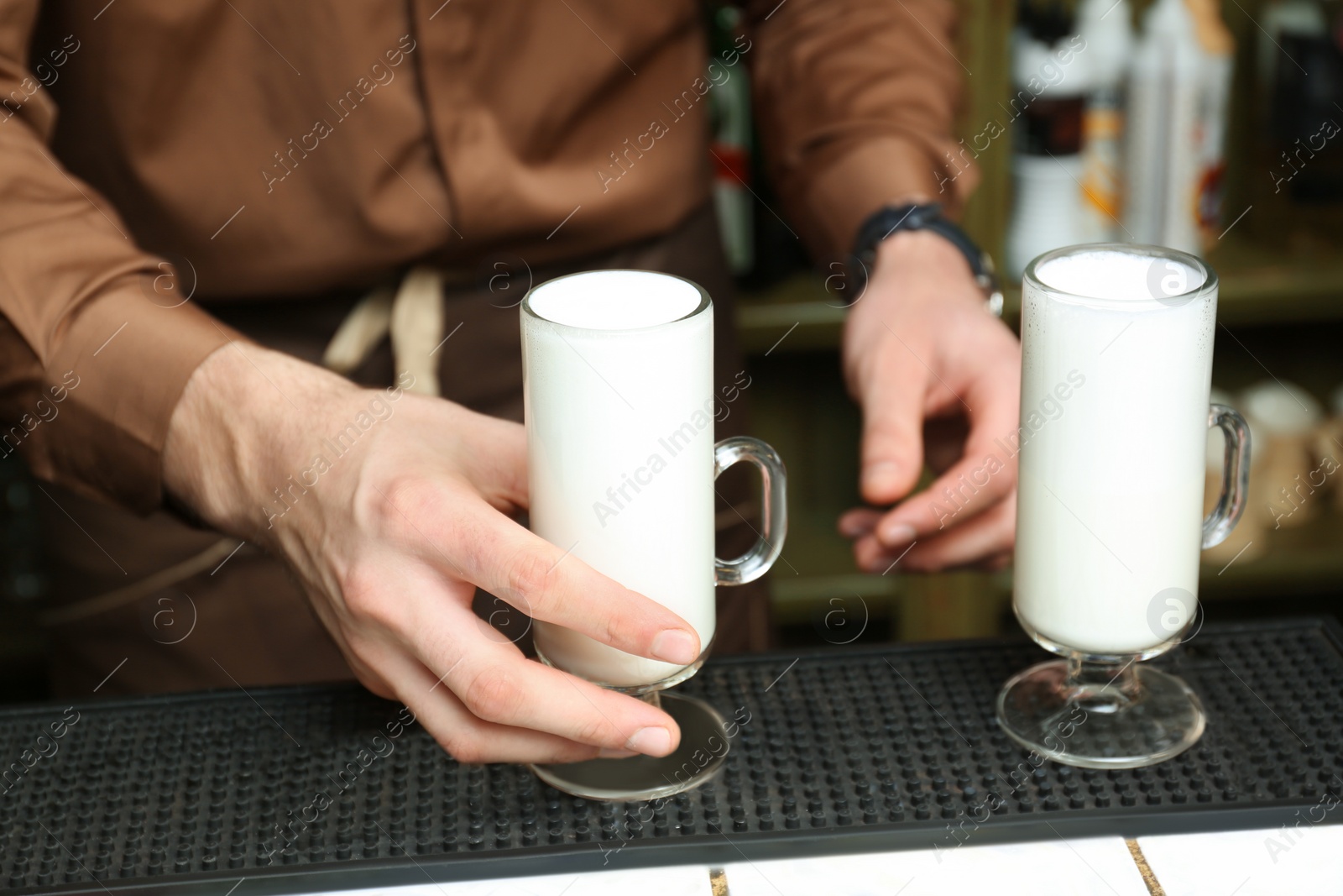 Photo of Barista preparing tasty coffee drink at counter, closeup