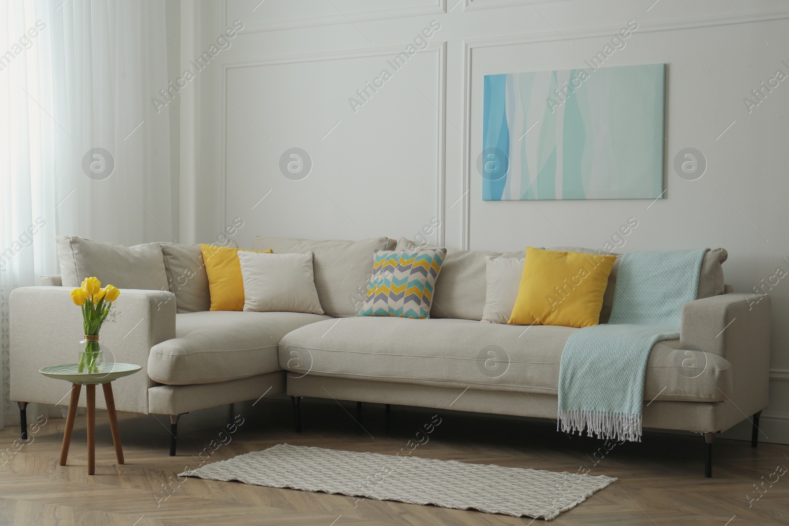 Photo of Stylish beige sofa in living room interior