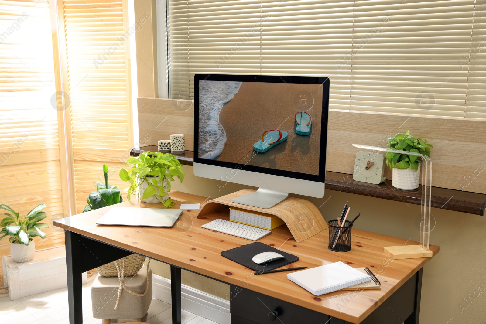 Photo of Comfortable workplace near window in room. Interior design