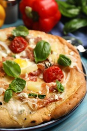 Photo of Delicious homemade pita pizza on light blue wooden table, closeup