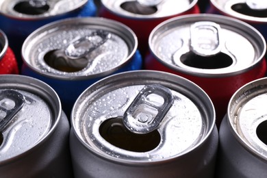 Photo of Energy drinks in wet cans as background, closeup. Functional beverage