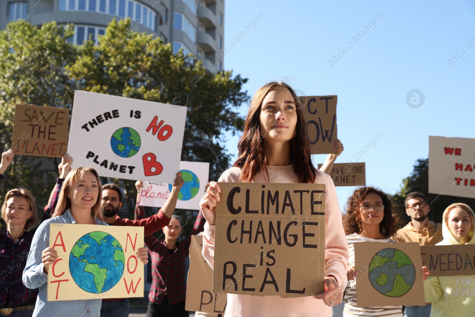 Photo of Group of people with posters protesting against climate change outdoors