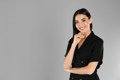 Portrait of young woman on light grey background. Space for text