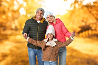 Image of Happy family spending time together at autumn park 