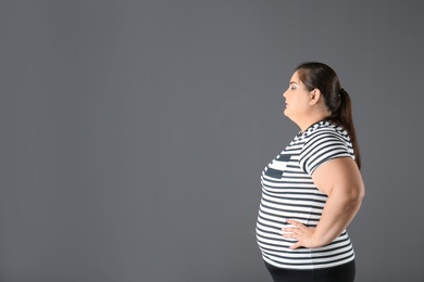 Photo of Portrait of overweight woman and space for text on gray background