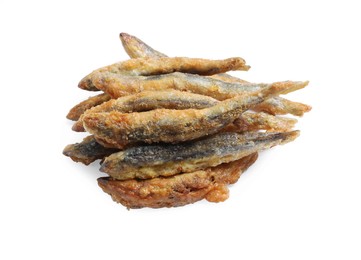 Photo of Pile of delicious fried anchovies on white background