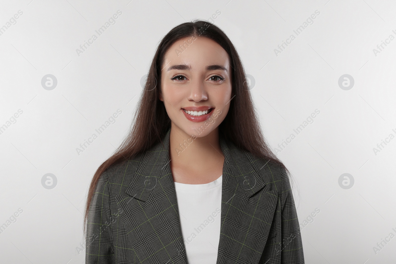 Photo of Portrait of happy young woman in stylish jacket on white background