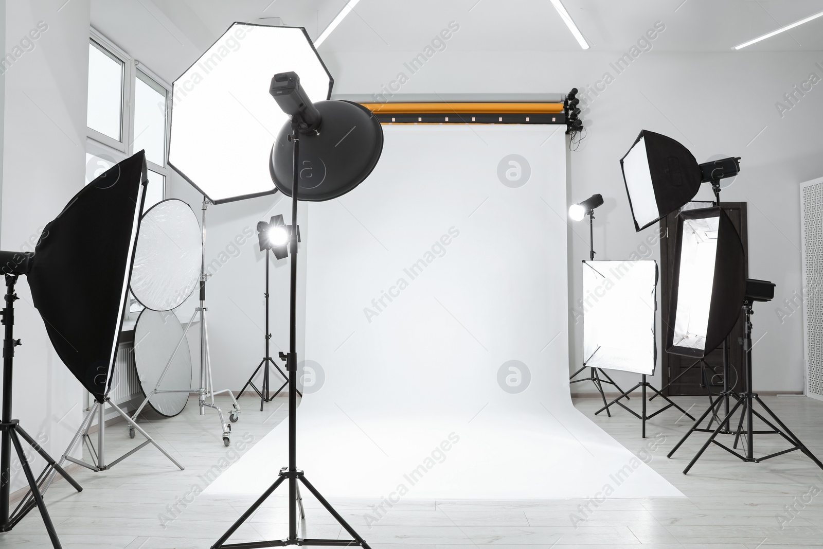 Photo of Interior of modern photo studio with professional lighting equipment