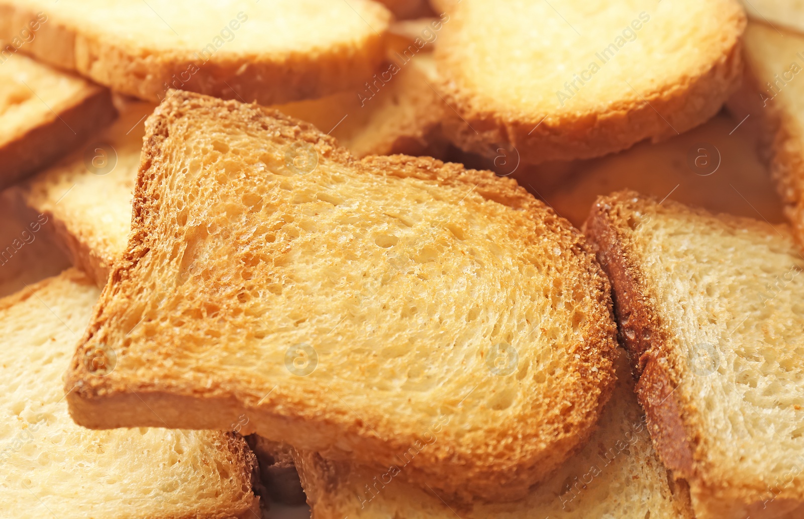 Photo of Toasted slices of bread as background, closeup