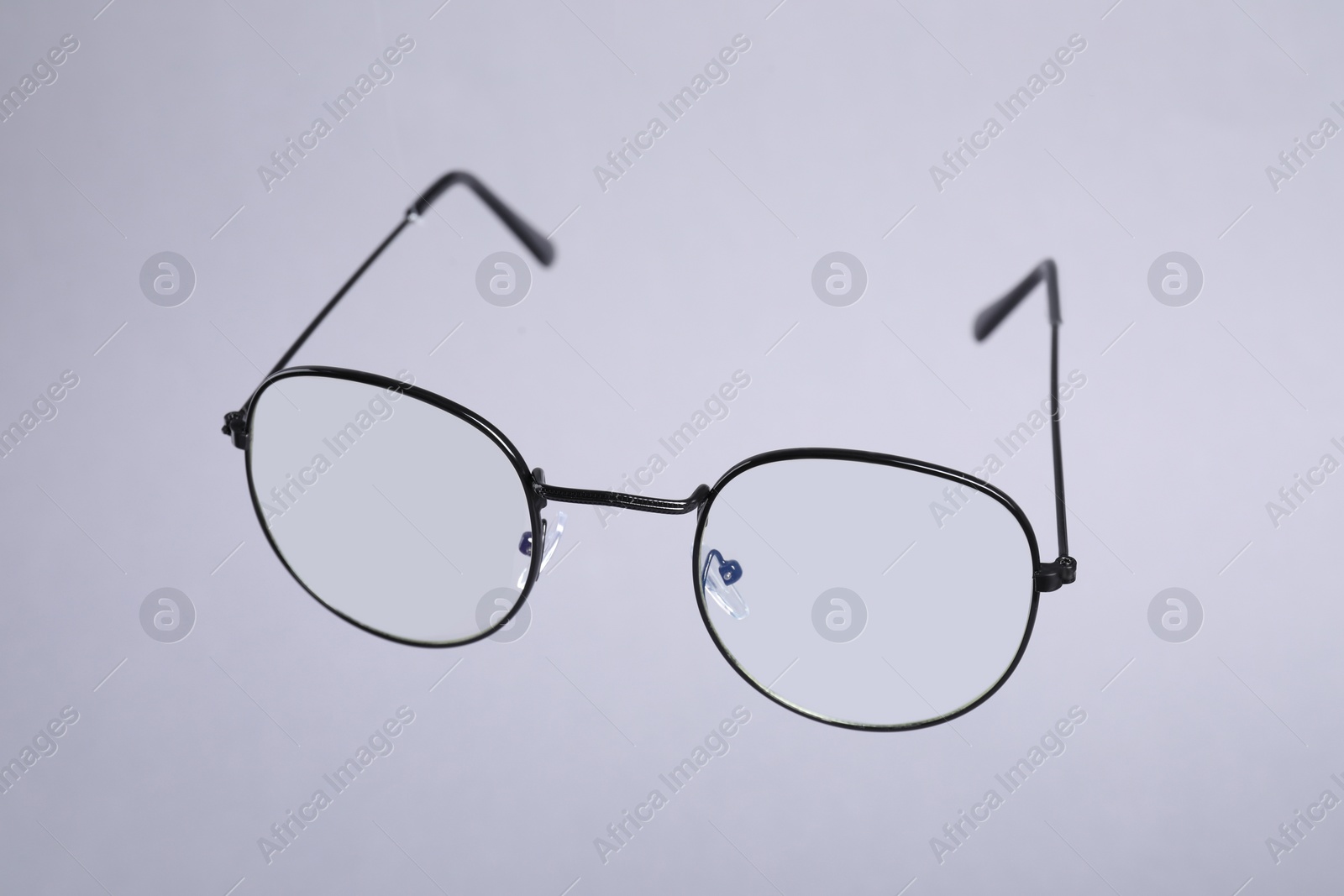 Photo of Stylish pair of glasses on light grey background