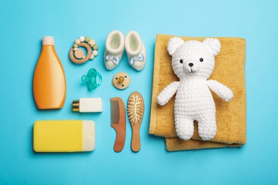 Flat lay composition with baby cosmetic products on turquoise background