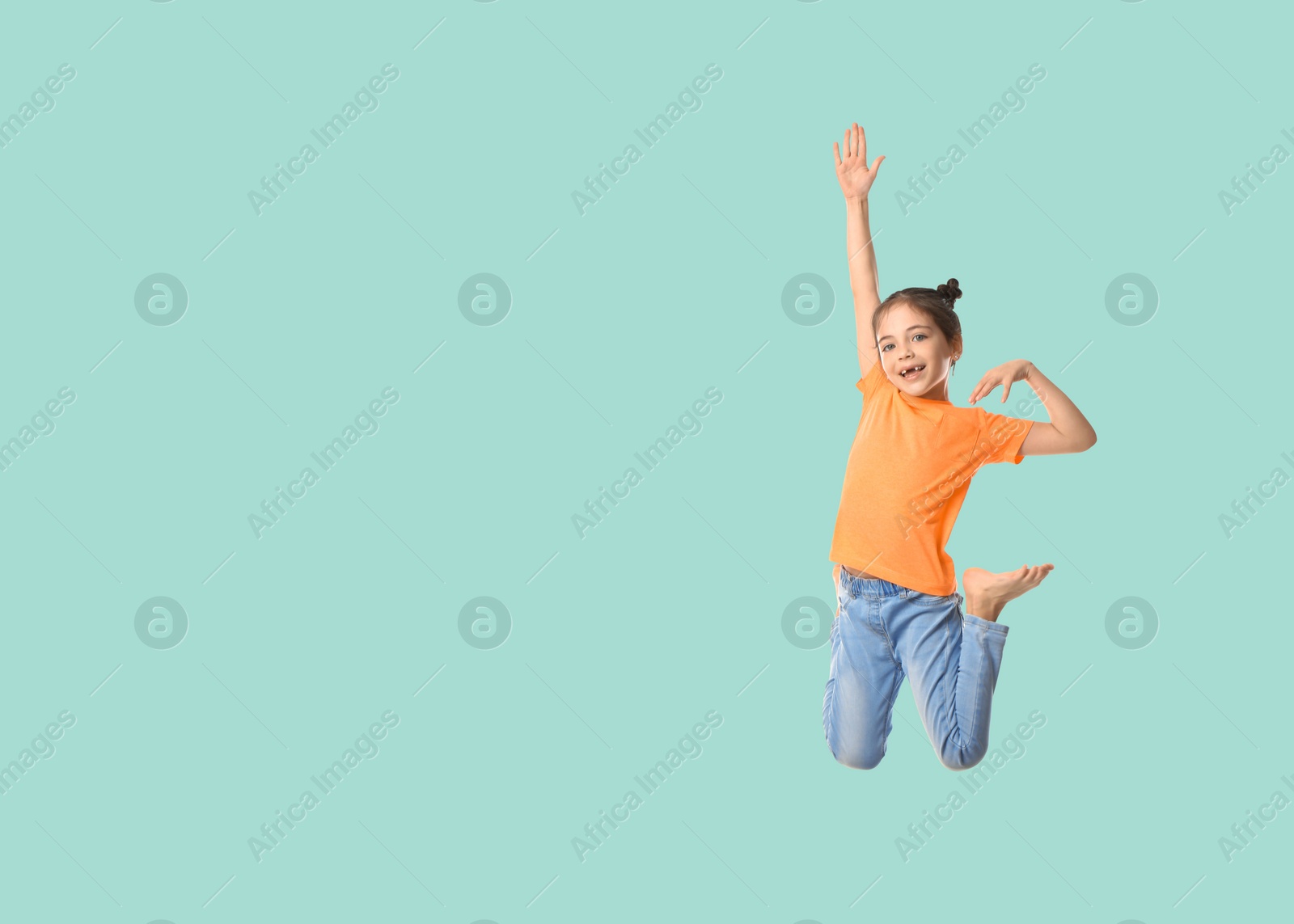 Image of Cute girl jumping on light blue background, space for text