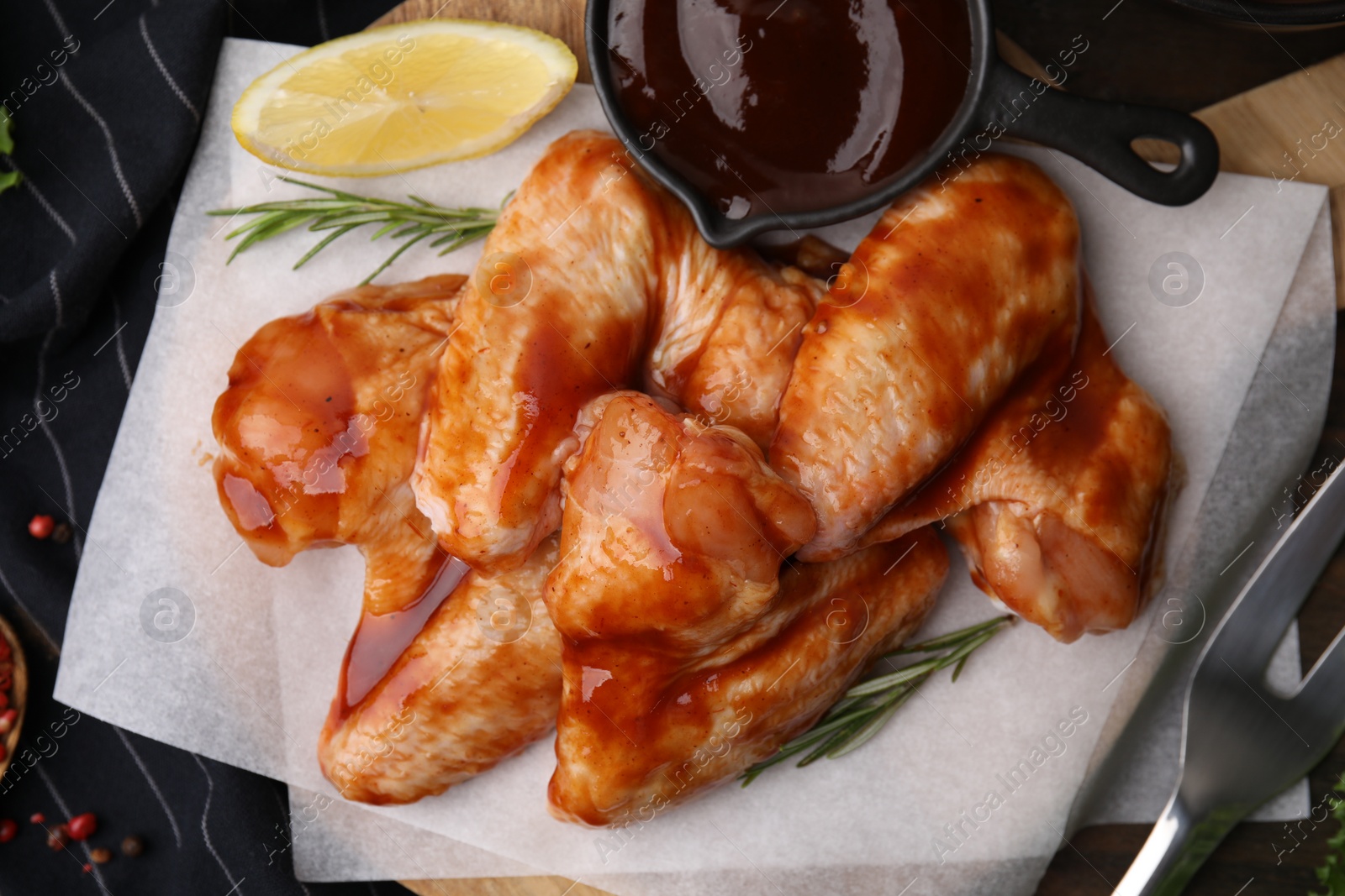 Photo of Fresh marinade, raw chicken wings and spices on table, top view