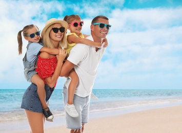 Image of Happy family near sea on sunny day. Summer vacation
