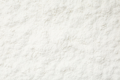 Photo of Pile of organic flour as background, top view