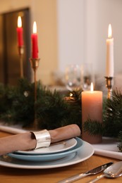 Luxury place setting with beautiful festive decor for Christmas dinner on wooden table