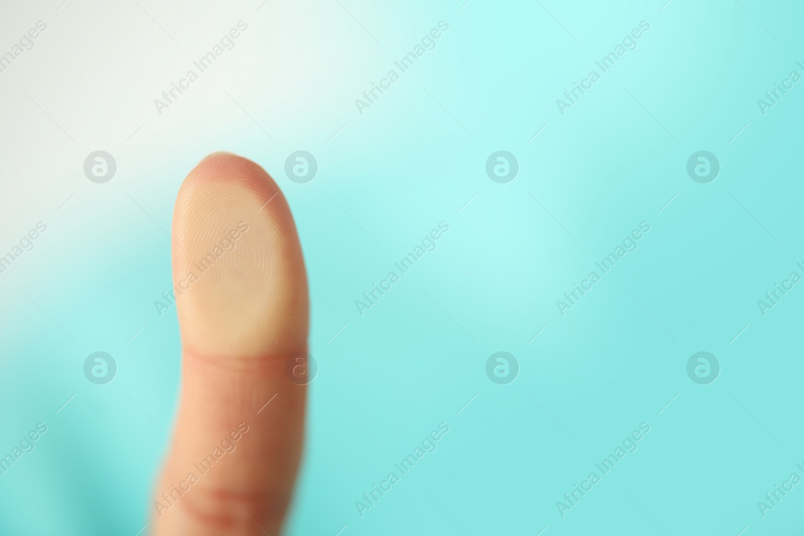 Photo of Woman scanning fingerprint on blurred background, closeup. Space for text