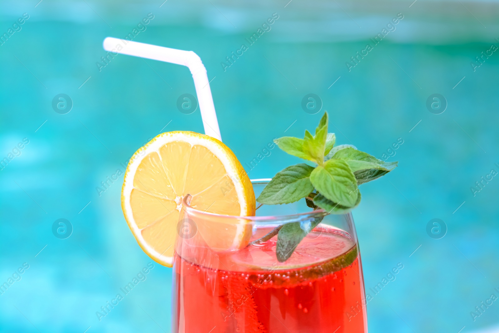 Photo of Glass of delicious cocktail on blurred background, closeup. Refreshing drink