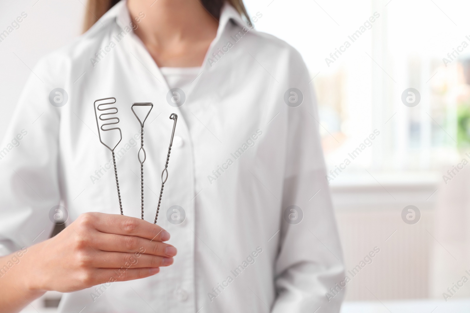 Photo of Speech therapist with logopedic probes in clinic, closeup. Space for text