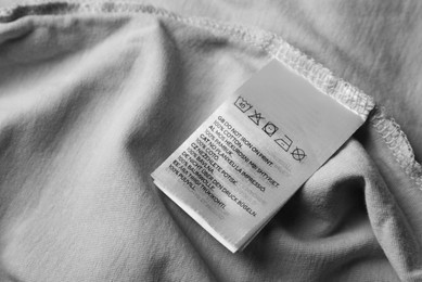 Photo of Clothing label on pale olive garment, closeup