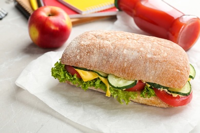 Photo of Delicious sandwich with fresh vegetables on table