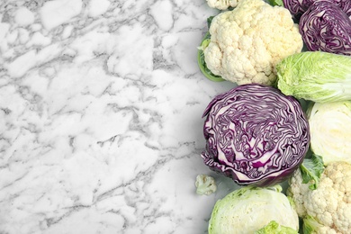 Photo of Flat lay composition with different cabbages on marble background