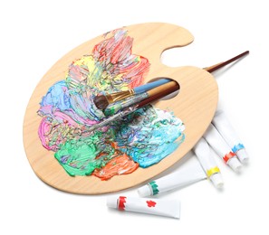 Photo of Palette with acrylic paints and brushes on white background. Artist equipment