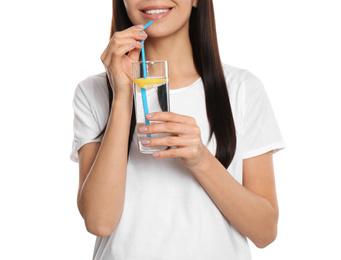 Photo of Young woman drinking tasty lemon water on white background, closeup