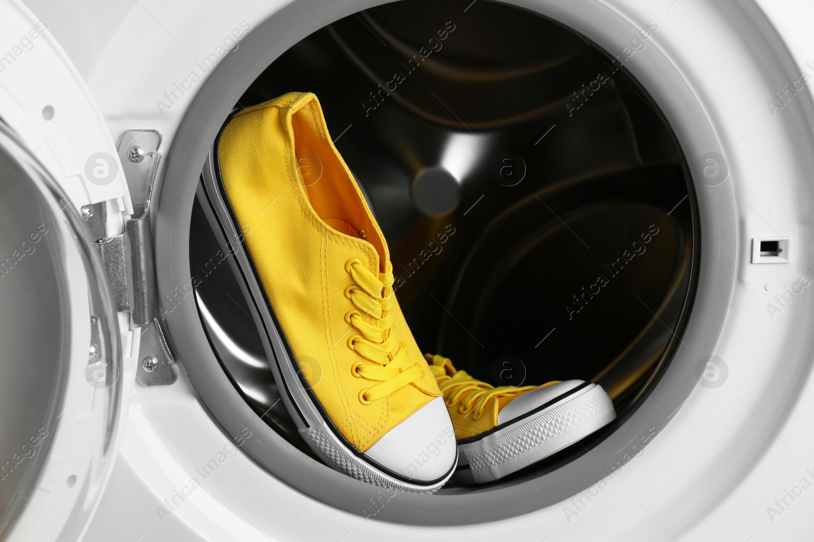 Photo of Clean sports shoes in washing machine drum