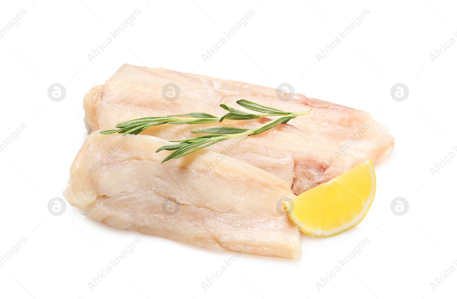 Photo of Pieces of raw cod fish, rosemary and lemon isolated on white