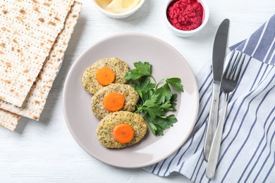 Photo of Flat lay composition with plate of traditional Passover (Pesach) gefilte fish on wooden background